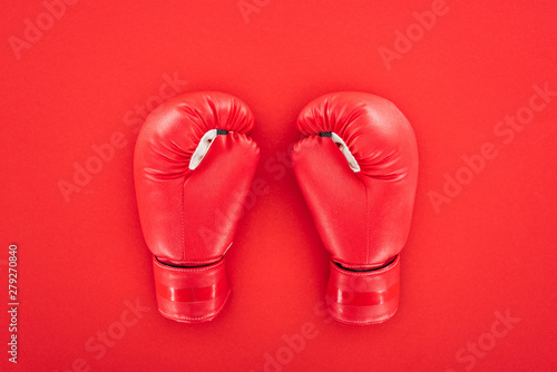 top view of pair of leather boxing gloves isolated on red © LIGHTFIELD STUDIOS