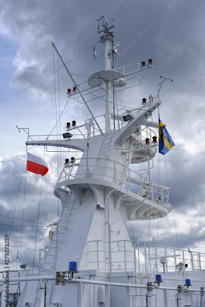 Satellite and communication equipment tower or mast on a large cruise ship with aerials and antennae against cloudy sky. Satellite and communication equipment tower or mast on a large cruise ship with aerials and antennae against cloudy sky.