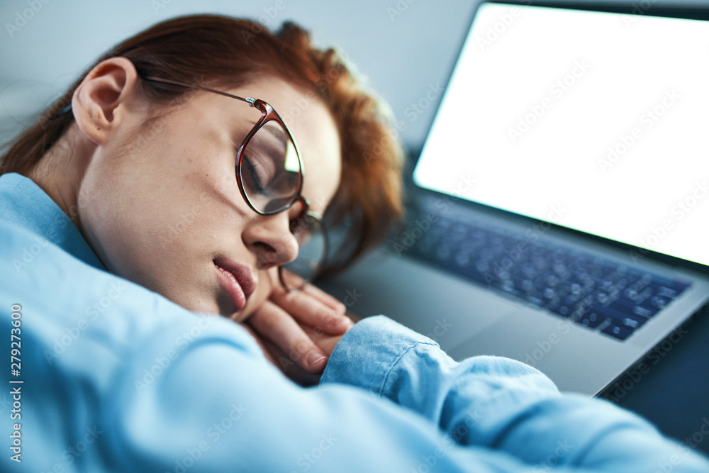 young man sleeping on his laptop