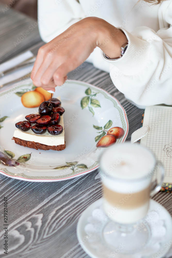 cherry cheesecake with latte in a cafe. Homemade breakfast with coffee. Great morning mood cherry cheesecake with latte in a cafe. Homemade breakfast with coffee. Great morning mood