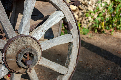 Wooden wheel upholstered with an iron hoop. Close-up, side view.