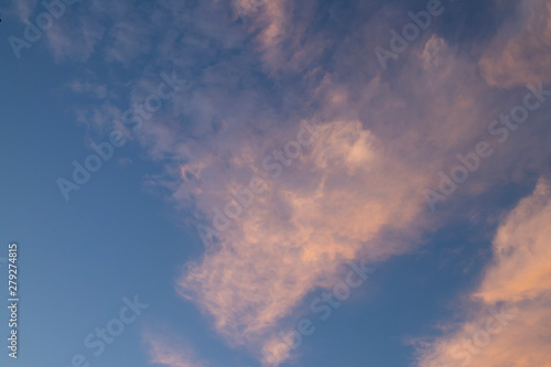 pink clouds at sunset against a blue sky