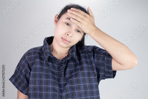 Asian young woman holding hand on forehead, suffering from feeling bad and sick. Health care concept.