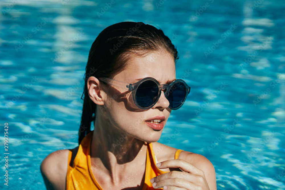 girl in blue goggles in swimming pool