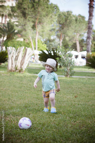 boy playing with a ball in the park