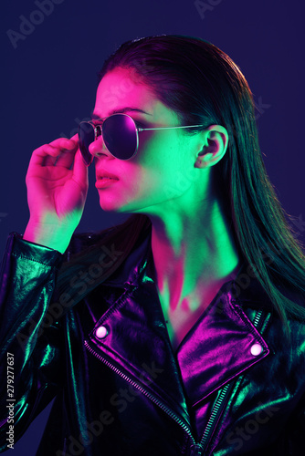 portrait of a young beautiful woman with perfect skin in neon light