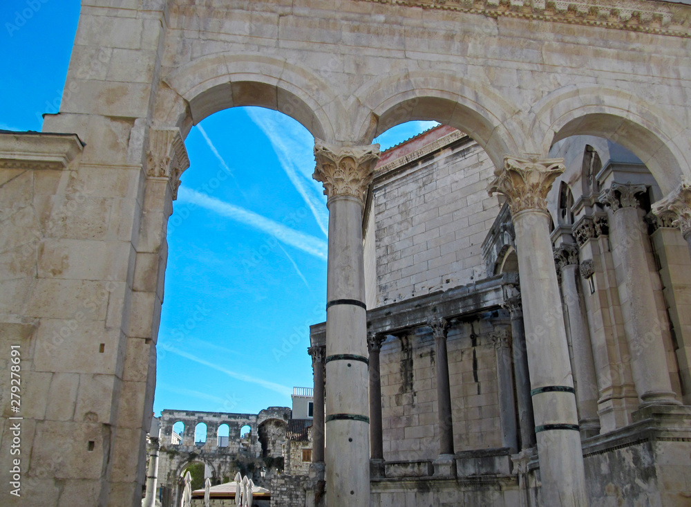 The Diocletian's Palace in Split, Croatia. Beautiful architecture of unique ancient buildings and many tourists in the old city on blue sky background on a sunny day. 