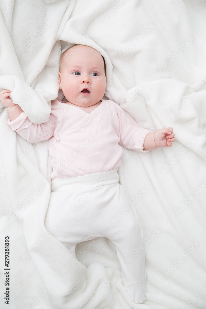 baby girl is lying on white blanket baby girl is lying on white blanket