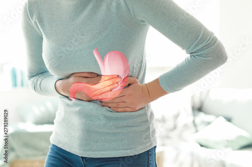 Fototapeta Naklejka Na Ścianę i Meble -  Young woman suffering from stomachache at home