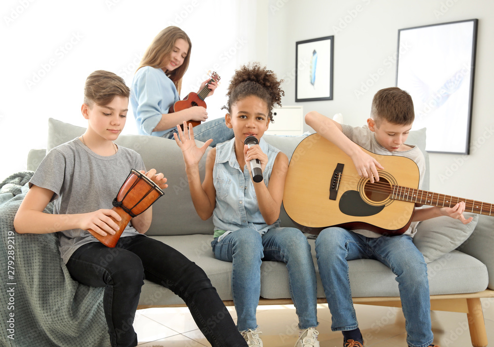 Fototapeta premium Teenage musicians playing and singing at home