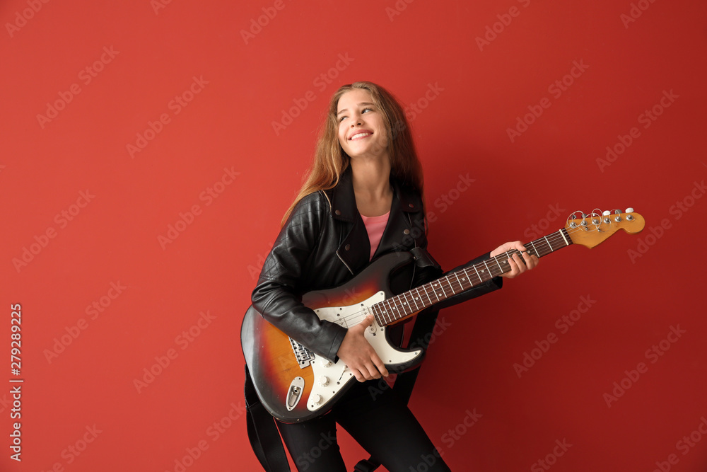 Teenage girl playing guitar against color background Teenage girl playing guitar against color background