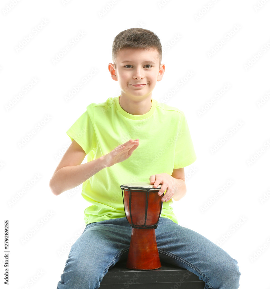 Teenage boy playing drum against white background Teenage boy playing drum against white background