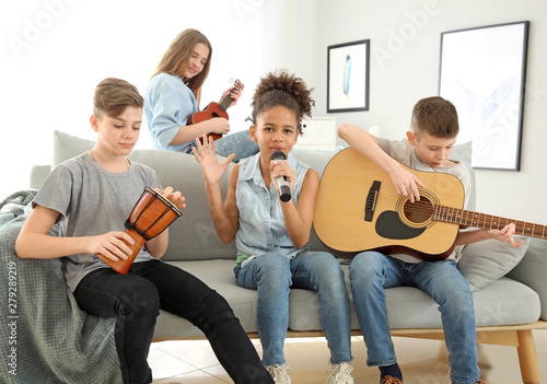 Teenage musicians playing and singing at home