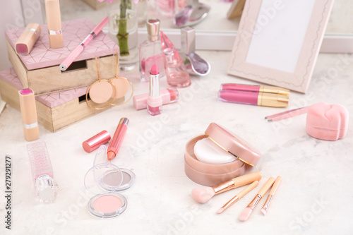 Makeup cosmetics with brushes on dressing table