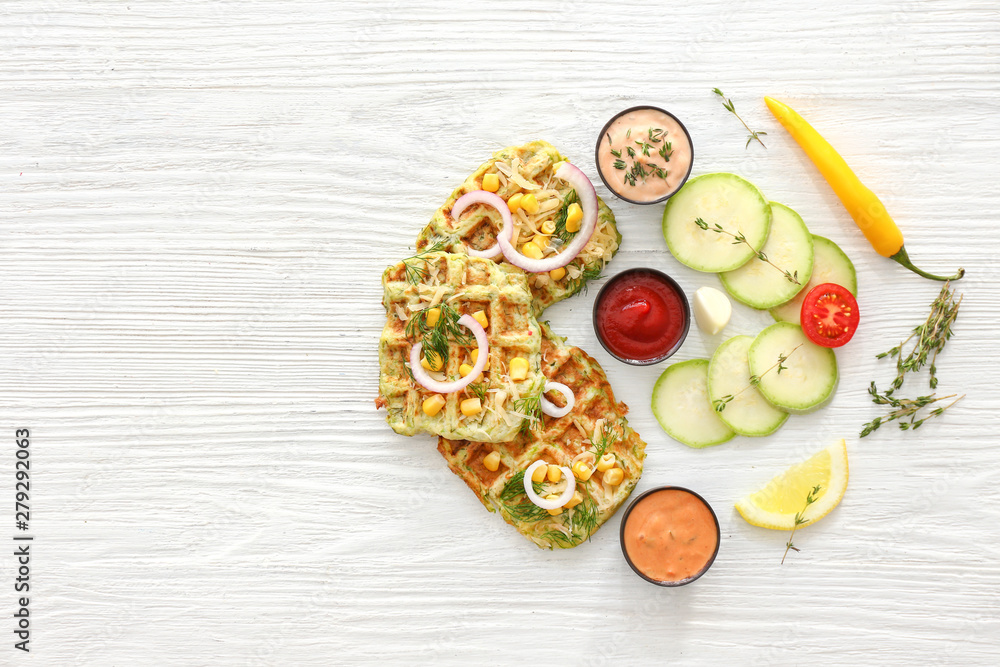 Tasty squash waffles with sauces on white table Tasty squash waffles with sauces on white table
