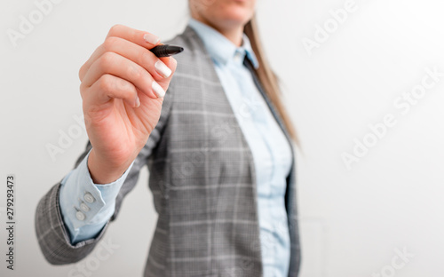 Business woman pointing in empty space with pen.