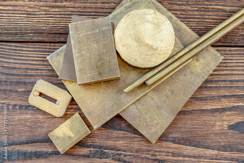 brass bronze copper alloys plates bars pins stock hole tubing thong sheet for knife handle knife making materials supply on the brown wooden background