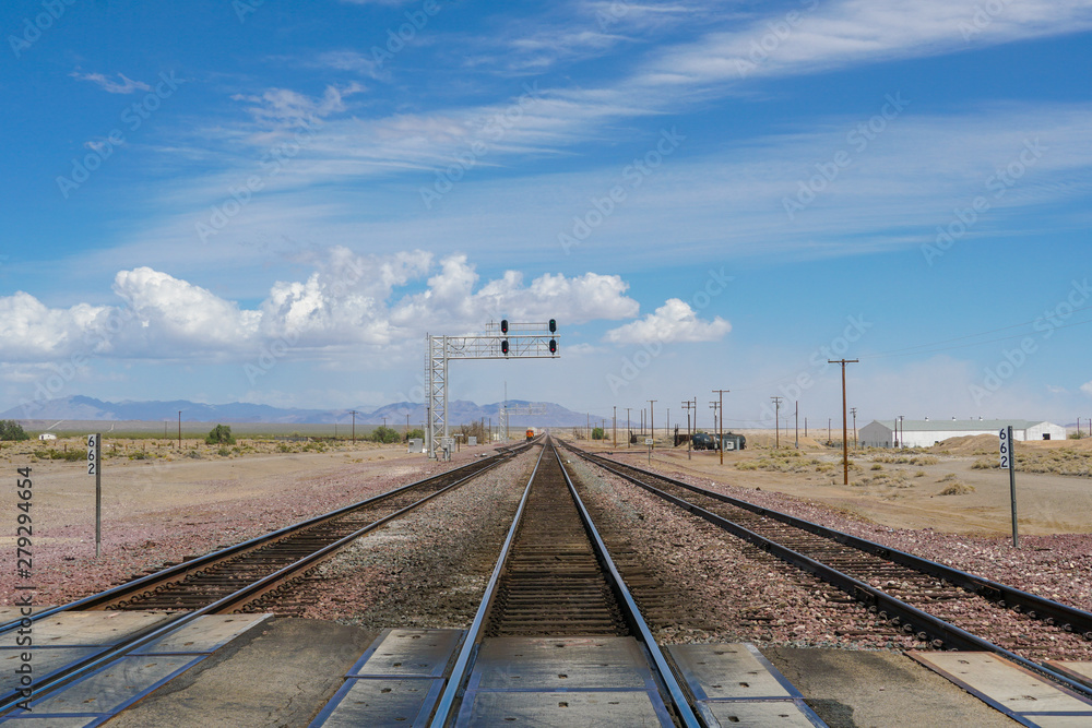 Railroad crossing gates on a road in the Mojave Desert in the Southwestern United States. California.