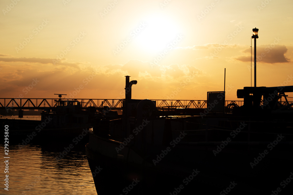 Beautiful Golden Sunset with Ships and Bridge Silhouettes At The River Danube in Belgrade Serbia Beautiful Golden Sunset with Ships and Bridge Silhouettes At The River Danube in Belgrade Serbia