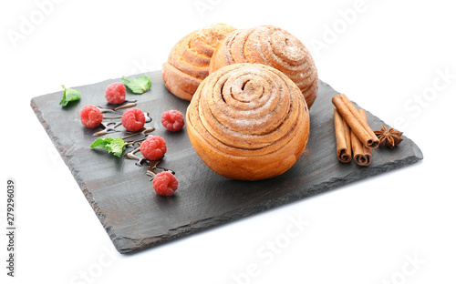 Slate plate with tasty cinnamon buns on white background