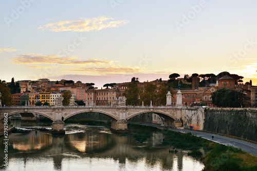 The eternal City. Embankment of the Tiber river and the view of the majestic Rome (Italy) with its bridges and beautiful architecture at sunset.