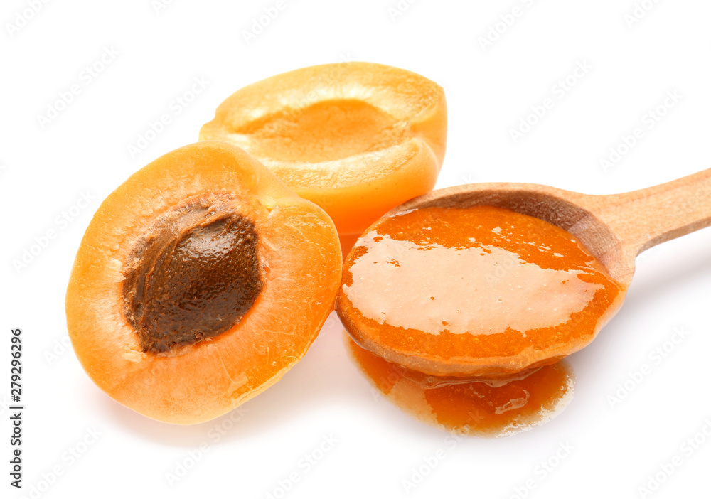 Spoon with tasty apricot jam on white background, closeup Spoon with tasty apricot jam on white background, closeup
