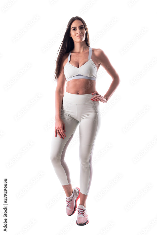 Fit young sport woman in white tights and top posing and looking at camera. Full body isolated on white background. Fit young sport woman in white tights and top posing and looking at camera. Full body isolated on white background.