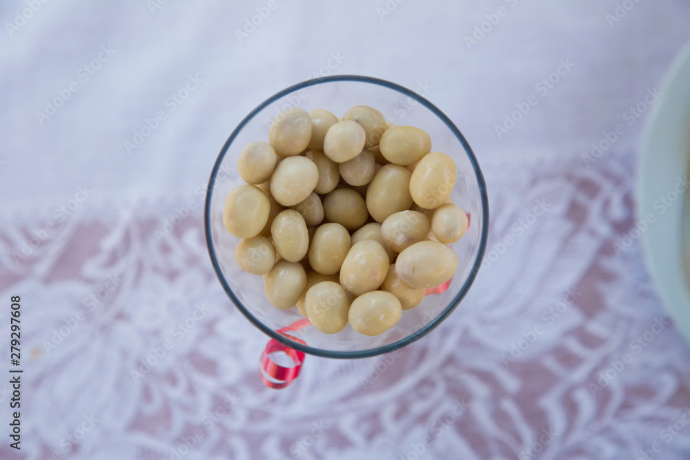 in a glass jar .In a round white chocolate glass . white chocolate balls with almond heart. in a glass jar .In a round white chocolate glass . white chocolate balls with almond heart.