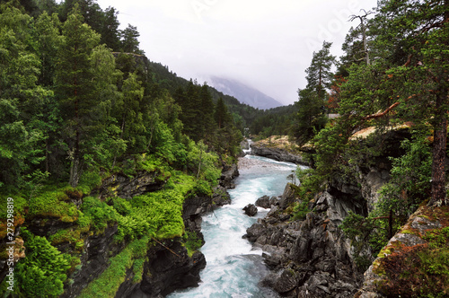 Norwegian turbulent mountain river in blue color