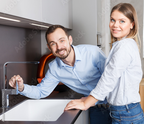 Couple looking at kitchen in salon