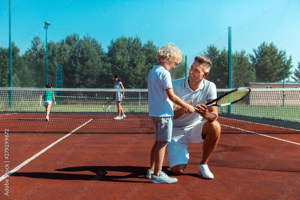 Fototapeta premium Happy father smiling while enjoying weekend with his son
