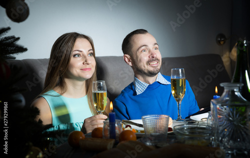 Cheerful couple celebrating Christmas