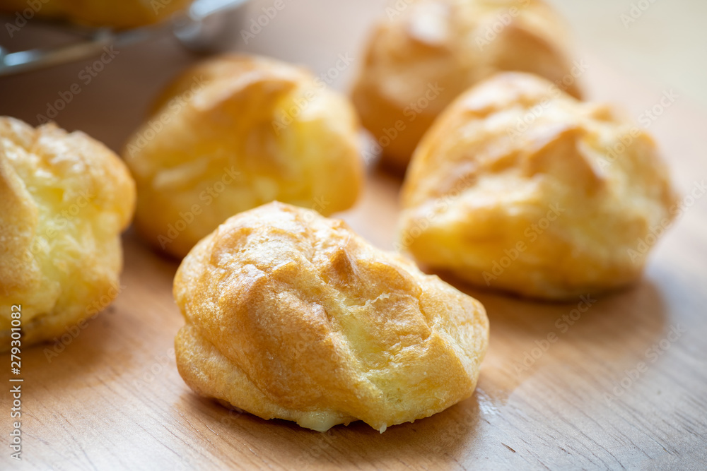 Close up of choux cream on wooden background