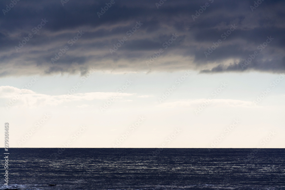 Large copy space for text on sky stripe between sea and clouds, sunrise on summer day Large copy space for text on sky stripe between sea and clouds, sunrise on summer day