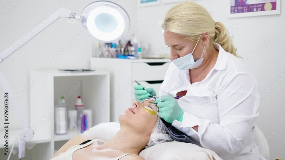 Procedure of eyelash extension in salon by cosmetician Procedure of eyelash extension in salon by cosmetician