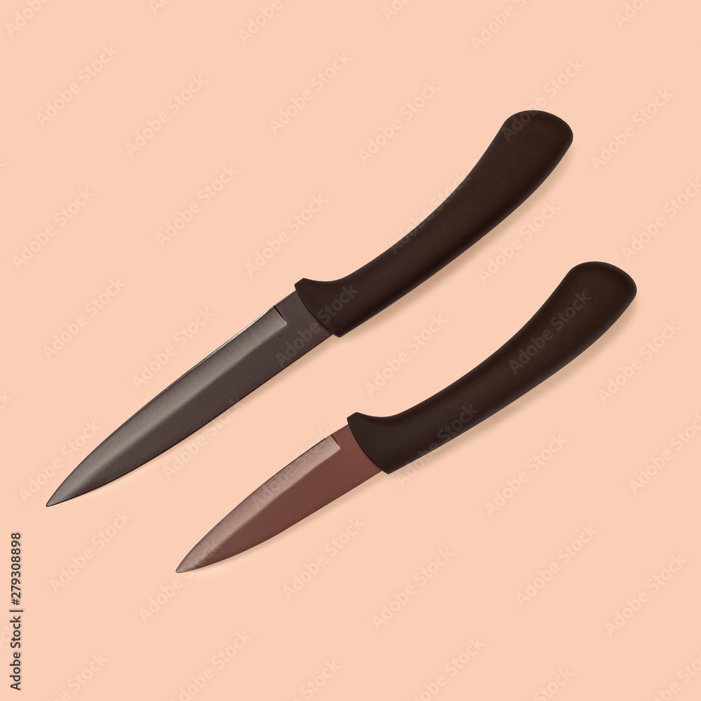 Top view on pair of kitchen knives isolated on colorful background Top view on pair of kitchen knives isolated on colorful background