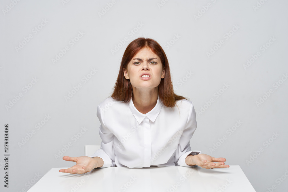 young angry businesswoman sitting at her desk young angry businesswoman sitting at her desk