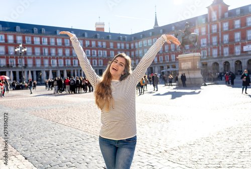 Attractive happy young woman enjoying spanish sightseeing in Madrid. In tourism in European city.