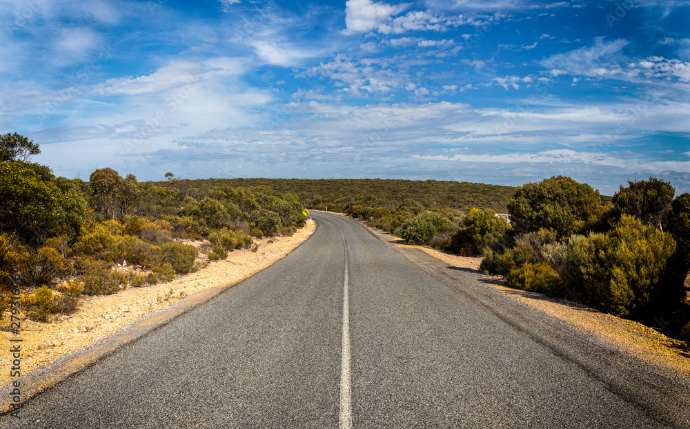 Australian outback road on a sunny day with blue sky