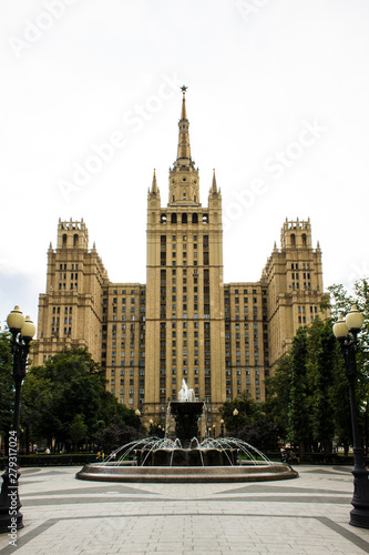 Fountain on the background of the historic brick high-rise cloudy summer day Moscow Russia