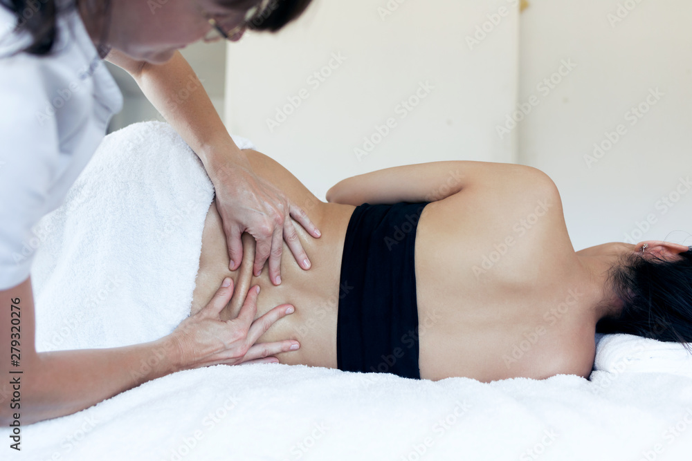 Φωτογραφία Female physiotherapist cures back pain of a pregnant woman in spa center