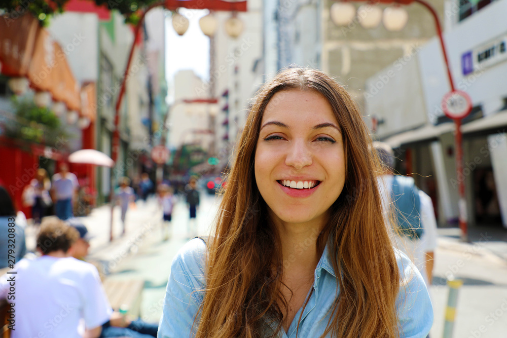 Happy beautiful smiling girl walking in Sao Paulo japanese neighborhood Liberdade, Sao Paulo, Brazil Happy beautiful smiling girl walking in Sao Paulo japanese neighborhood Liberdade, Sao Paulo, Brazil
