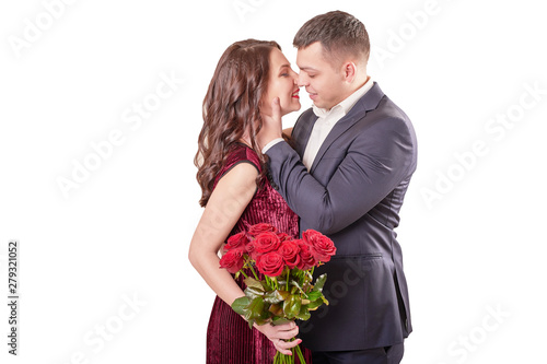 young married couple with a bouquet of red roses on a beige background on February 14 in Valentine's Day