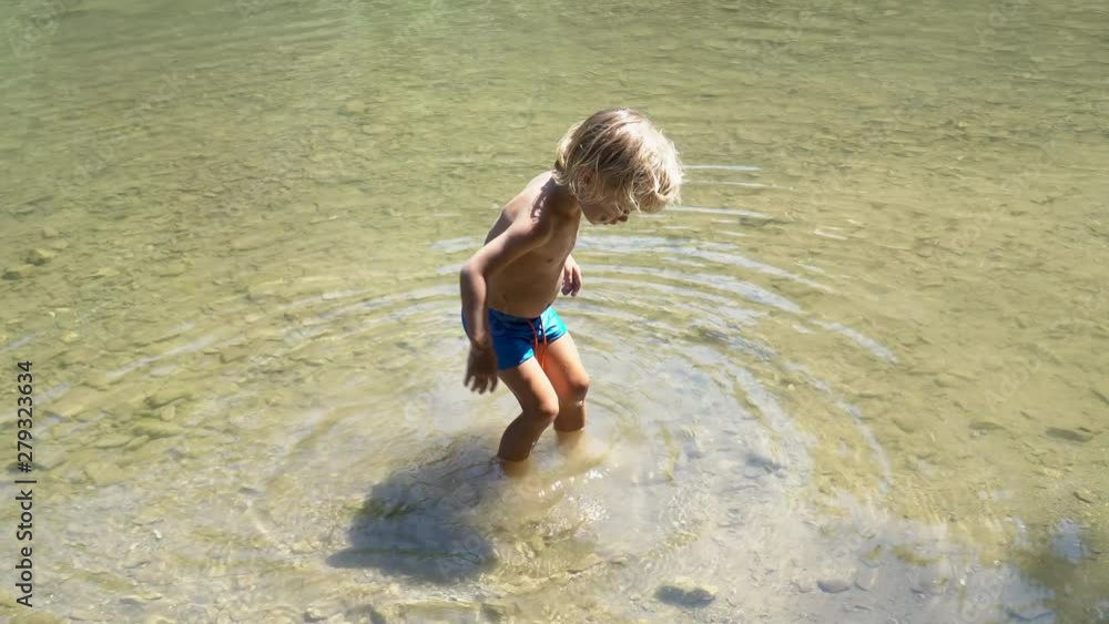 little boy bathes in a river. river in the forest. swimming in the river. concept - vacation. little boy bathes in a river. river in the forest. swimming in the river. concept - vacation.
