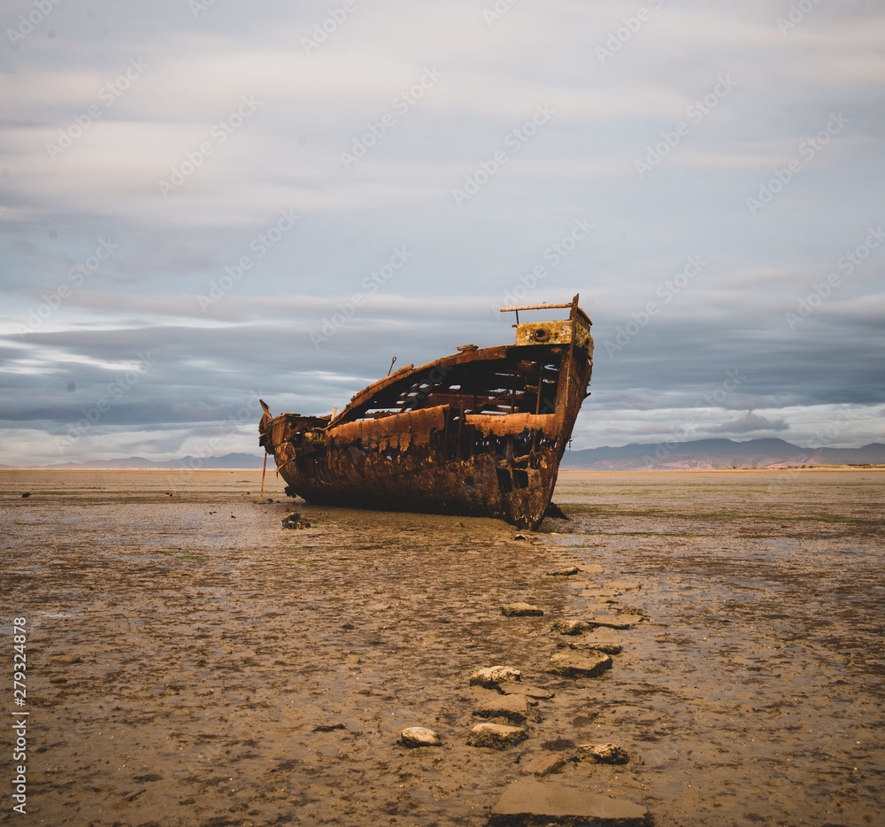 old fishing boat stuck on the beach