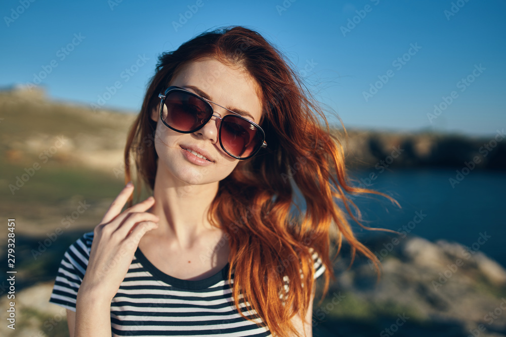 portrait of young woman in sunglasses nature