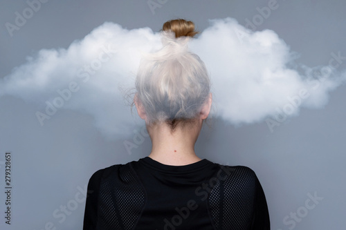 Young girl simple hairstyle back view with cloud on her head. Fashionable and simple hairdresser work. Fashion model, trendy woman. Hair in top bun close-up photo. Mental health metaphor concept