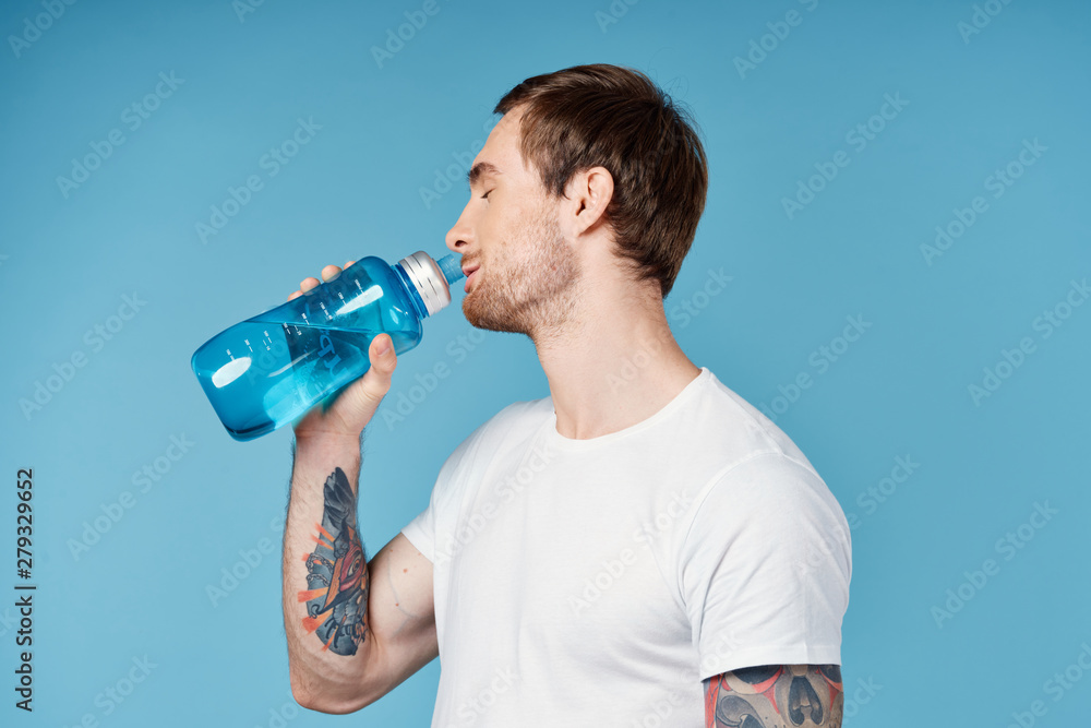 man drinking water on a blue background man drinking water on a blue background
