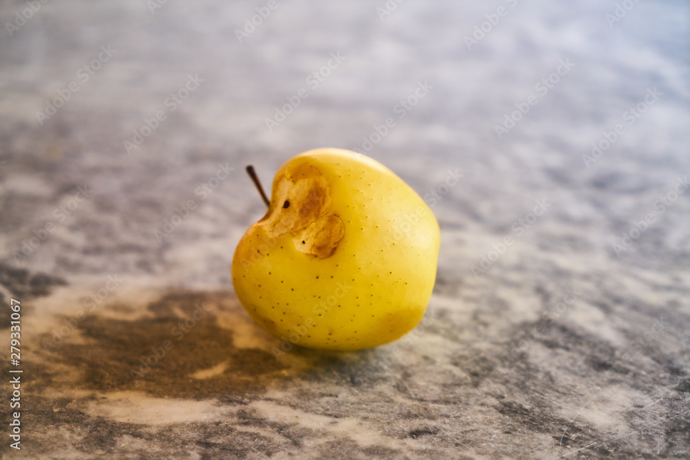 bitten yellow apple on the table bitten yellow apple on the table