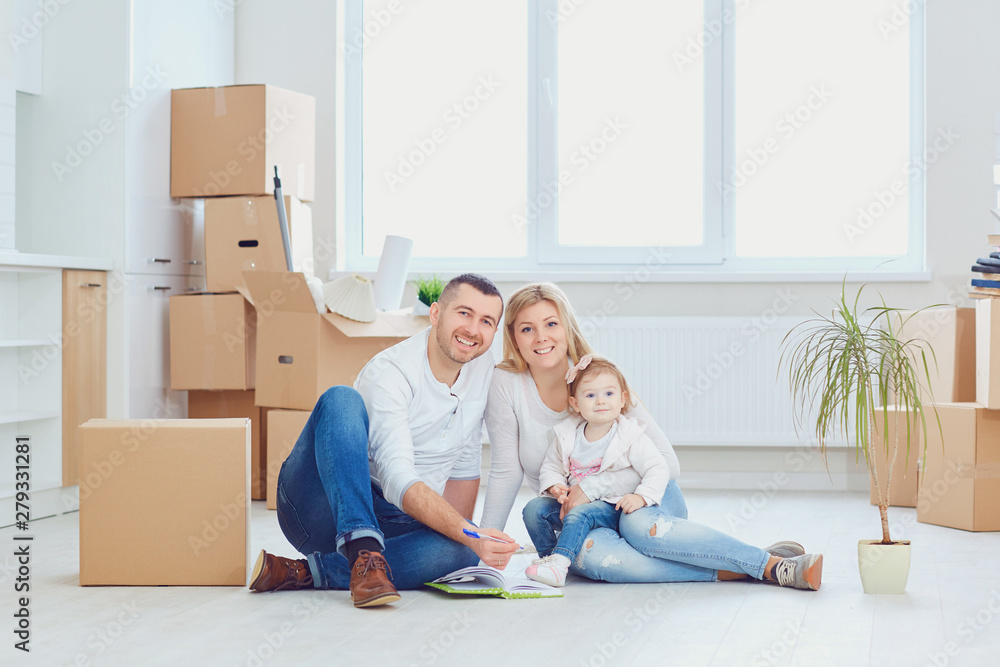 Happy couple unpacking boxes at new house Happy couple unpacking boxes at new house